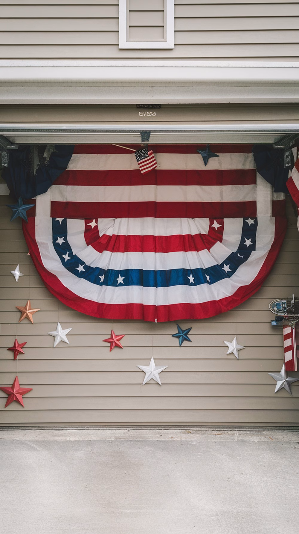 A garage decorated with a large American flag and colorful stars for a 4th of July party.
