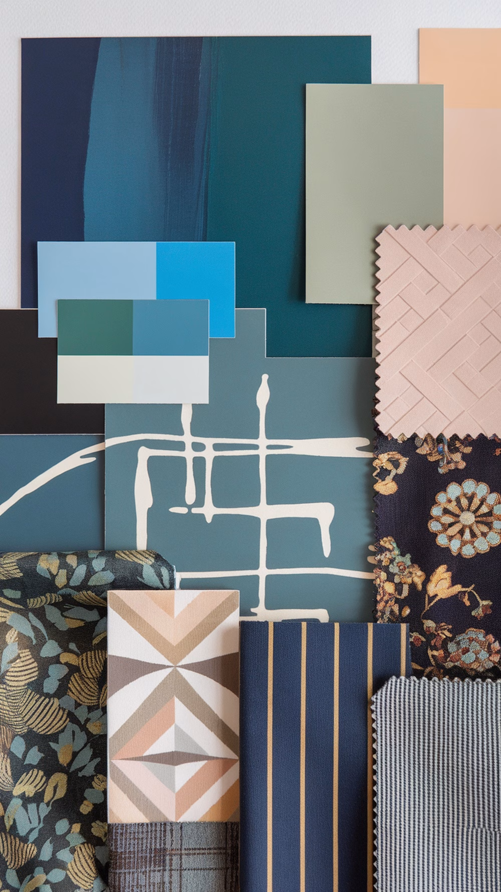 A collection of color swatches and fabric samples for a garage conversion project.