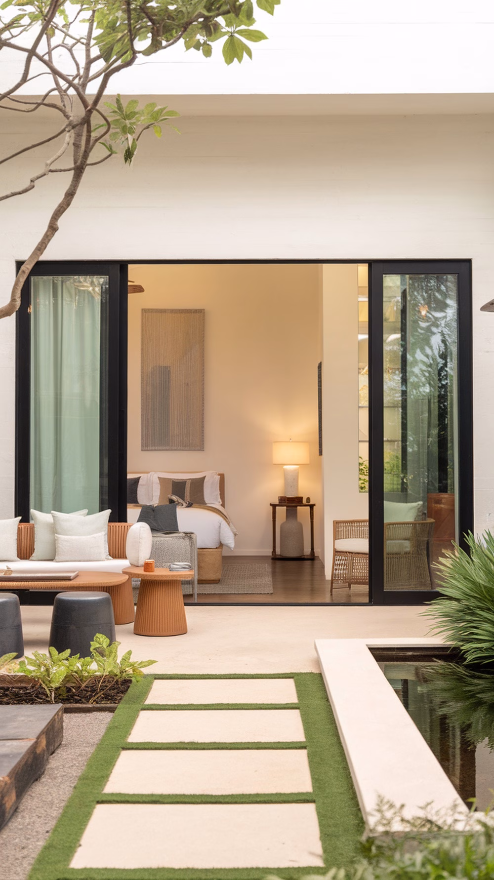 A cozy outdoor area leading to a guest suite with comfortable seating and a pathway.